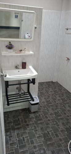 a bathroom with a sink and a mirror and a toilet at TR Hotel Udon Thani in Ban Dong Kheng