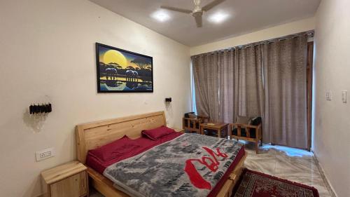 a bedroom with a large bed with red pillows at Northbound Kasol in Kasol