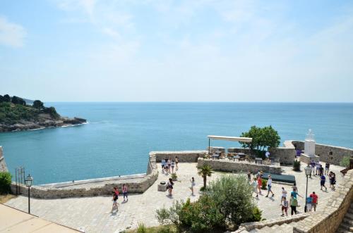 a group of people walking on the stairs next to the ocean at Villa Marinero in Ulcinj