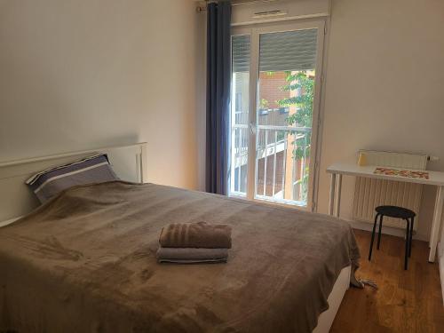 a bedroom with a large bed with a window at 1 chambre double privée et securisée dans un appart avec espace partagé in Saint-Denis
