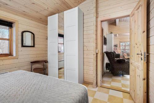 a bedroom with a bed in a wooden room at LF10999-Thyholm-Ringvejen-9 in Thyholm