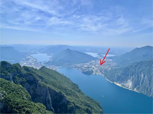 a red object is flying over a body of water at Rosa dei Venti - Como Lake House in Valmadrera