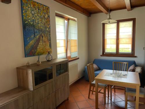 a living room with a tv and a dining room table at LI DA BIS Affittacamere in Avasinis