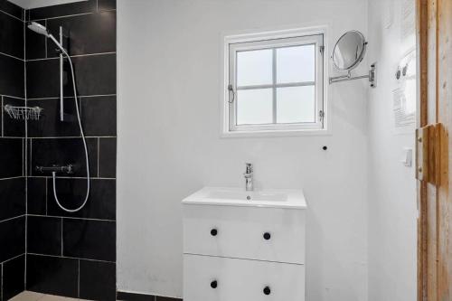 a white bathroom with a sink and a shower at LF391-Vestervig-Gunhildsvej-1 in Vestervig