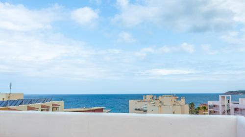 a view of the ocean from a balcony at Apartamentos San Antonio Beach in San Antonio Bay