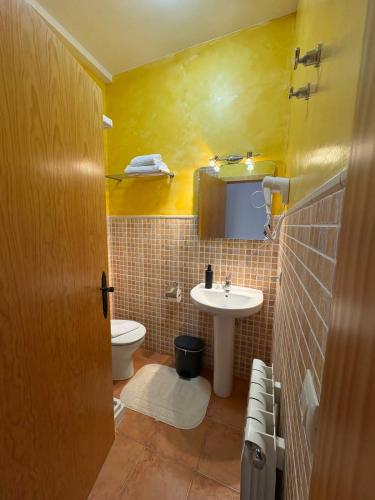 a small bathroom with a sink and a toilet at Casa Rural Tronchon in Tronchón