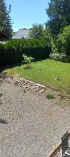 a garden with a stone path in a yard at Joli studio sympa in Saint-Jean-Saint-Nicolas
