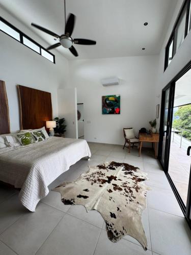 a bedroom with a large bed and a rug on the floor at Villa Montemar Ocean and Mountain Views in Platanillo
