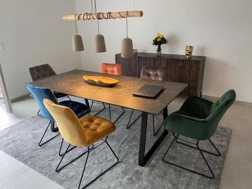 a dining room table with chairs and a laptop on it at TLA-A-K83a in Bruchmühlbach-Miesau