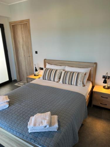 a bedroom with a bed with two towels on it at Vassiliki in Paleros