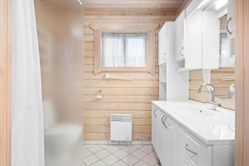 a white bathroom with a sink and a shower at LF15156-Hojslev-Mosevej-156 in Højslev