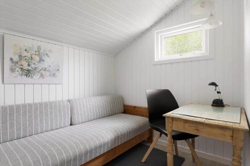 a room with a couch and a desk and a table at LF16310-Nibe-Alerusen-97 in Nibe
