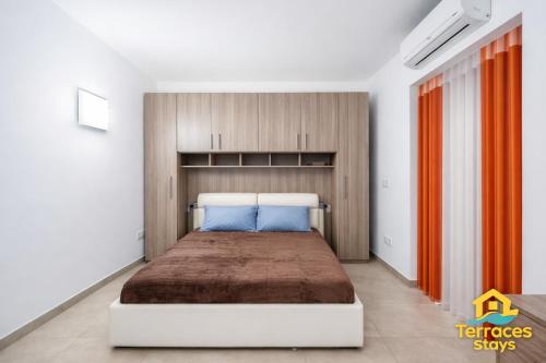 a bedroom with a large bed in a room at The Terraces Seafront Getaway Malta 3 Bedroom Apartment in St. Paul's Bay