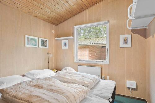 a bedroom with a bed in a room with a window at LF15191-Hojslev-Ternevej-31 in Højslev