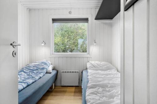 a small bedroom with a bed and a window at LF160-Vestervig-Gunhildsvej-60 in Vestervig
