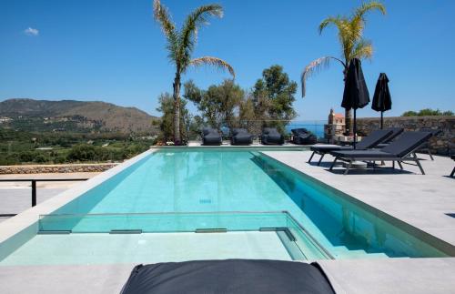 a swimming pool with a view of the ocean at Villa Manel in Georgioupoli