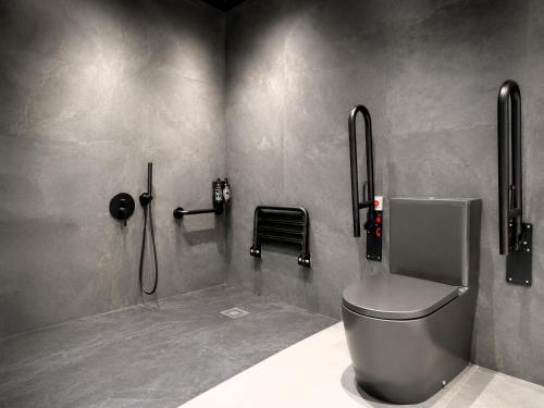 a bathroom with a toilet and a shower at Yomo Hostal BCN Port in Barcelona