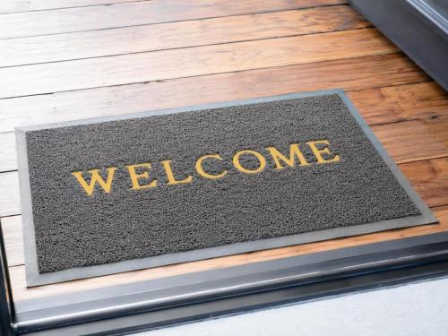 a welcome sign on the front of a building at Pecan Tree Lodge in Cape Town