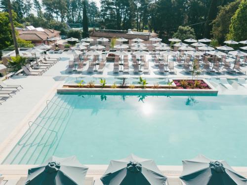 an overhead view of a pool with umbrellas and chairs at Iolida Corfu Resort by Smile Hotels in Dassia