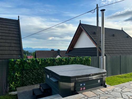 a barbecue grill sitting in front of a house at Glamoon Mountain Apartment with Jacuzzi and Sauna, Nowy Targ in Nowy Targ