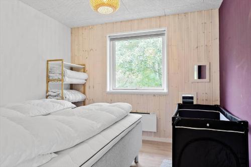 a bedroom with a large bed and a window at LF14143-Spottrup-Basaltvej-1 in Spottrup