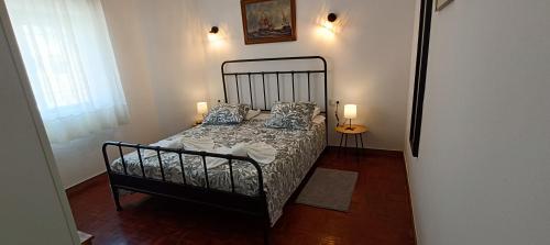 a bedroom with a bed and two lamps on a floor at Villa Golden Coast - Lagos in Lagos