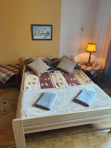 a bedroom with a bed with two pillows on it at Sielankowy Domek in Istebna