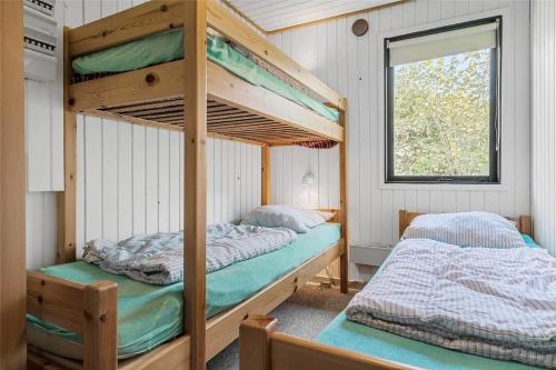 two bunk beds in a room with a window at LF14102-Roslev-Eskovvej-102 in Roslev