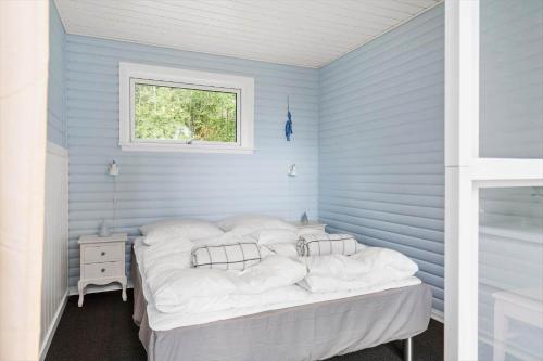 a blue room with a bed and a window at LF15319-Hojslev-Jelsevej-319 in Højslev