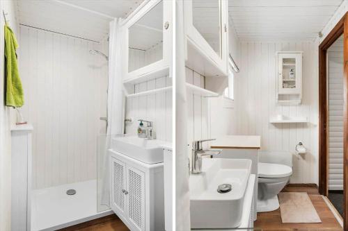 a white bathroom with a sink and a toilet at LF15319-Hojslev-Jelsevej-319 in Højslev