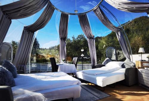 a room with two beds and a large window at Banpim Aroradome and jacusszy in Gravdal
