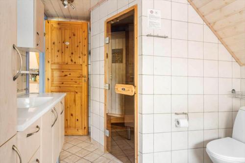 a bathroom with a toilet and a sink at 0142-Romo-Ivigtut-1 in Høm