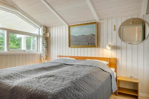 a bedroom with a bed and a mirror at LF694-Hurup-Thy-Haettemagevej-8 in Sindrup