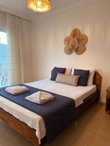 a bedroom with a large bed with a flower on the wall at KAJU ROOMS Bozburun in Bozburun