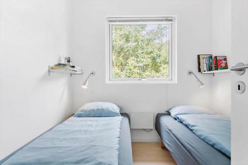 a bedroom with two beds and a window at LF338-Vestervig-Gunhildsvej-38 in Vestervig