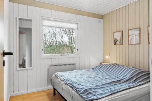 a bedroom with a bed and a window at LF11101-Struer-Blabaervej-12 in Struer