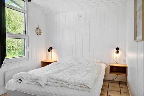 a white bedroom with a large bed and two windows at LF159-Vestervig-Gunhildsvej-39 in Vestervig