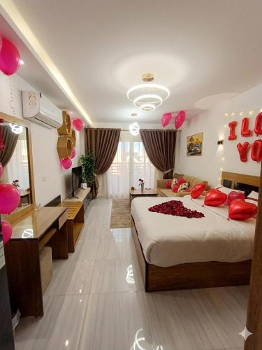 a bedroom with a large bed and a mirror at Luxury Studio Pool & Free Private Beach, Close to Airport in Hurghada