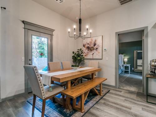 a dining room with a wooden table and chairs at Your Unforgettable Temporary Haven! in Edmond