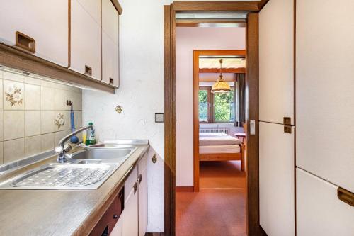 a kitchen with a sink and a door to a room at Ferienhaus Isele in Feldberg