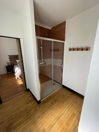 a room with a glass closet with a mirror at Chambres d'hôtes d'Isa in Bugeat