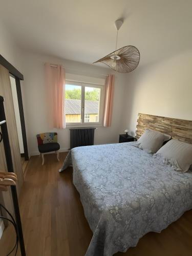 a bedroom with a large bed and a window at Chambres d'hôtes d'Isa in Bugeat