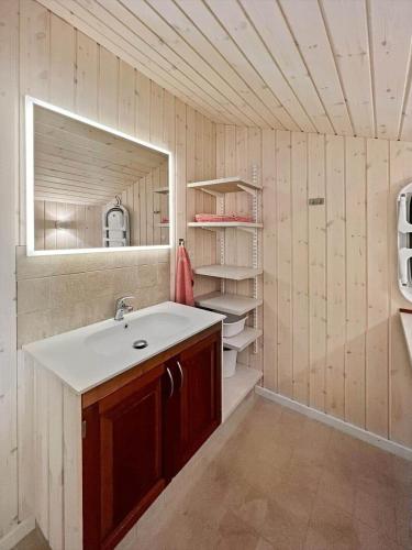 a bathroom with a sink and a mirror at 0143-Romo-Ejnar-Mikkelsensvej-11 in Høm