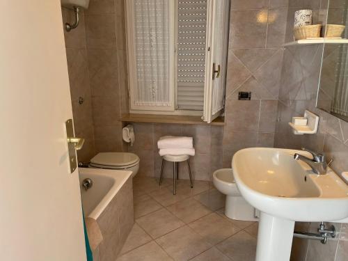 a bathroom with a sink and a toilet and a tub at Hotel Biancamaria in Anacapri