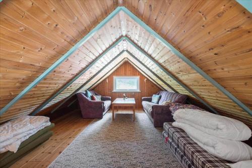 a room with two couches and a table in a attic at 0273-Romo-Lyngvejen-63-B in Høm