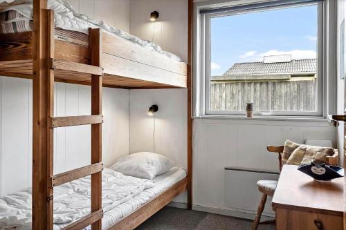 a bedroom with a bunk bed and a window at LF880-Snedsted-Over-Reese-11 in Snedsted