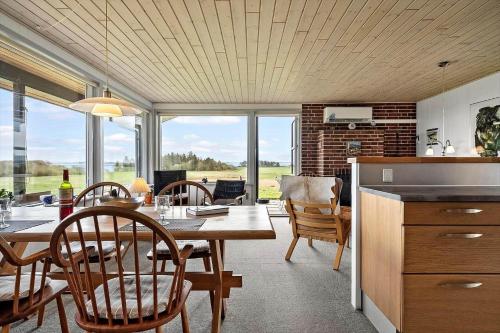 a kitchen and dining room with a table and chairs at LF880-Snedsted-Over-Reese-11 in Snedsted