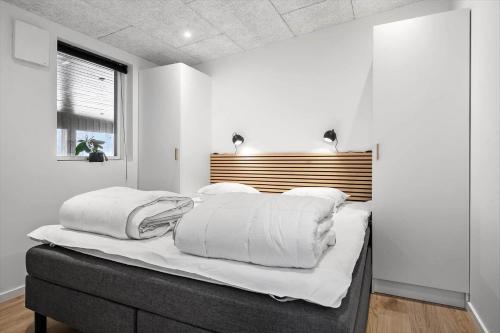a bedroom with white walls and a bed with white pillows at LF302-Hurup-Helligsovej-2-F in Hurup