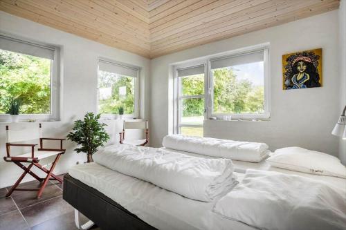 a bedroom with two large beds and two windows at LF271-Vestervig-Gunhildsvej-49 in Vestervig