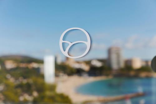 a blurry picture of the olympic logo on a window at Suites ROC Portonova - Newly Renovated 2026 in Palmanova